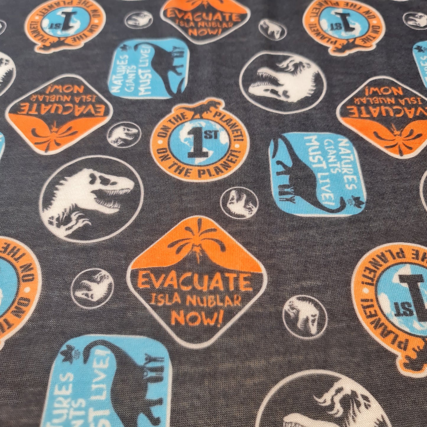 Dinosaur Cotton Jersey Fabric – “Evacuate Isla Nublar” Baby Grow Material (Soft Stretch, 58” Wide) By the Meter