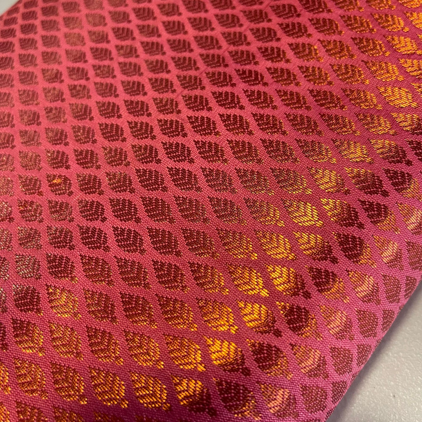 coral brocade fabric with metallic gold leaf print