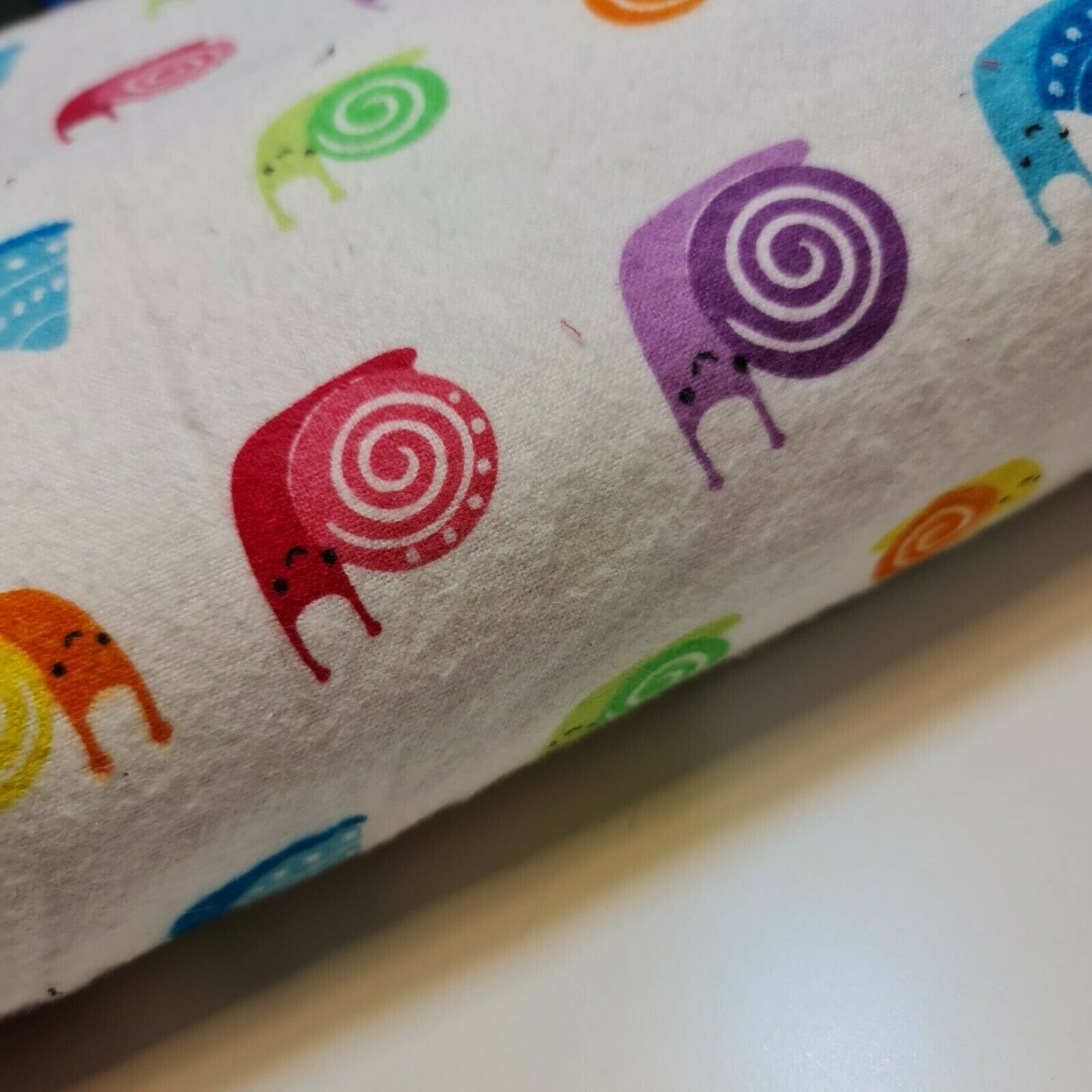 cotton winceyette fabric with smiley snails print