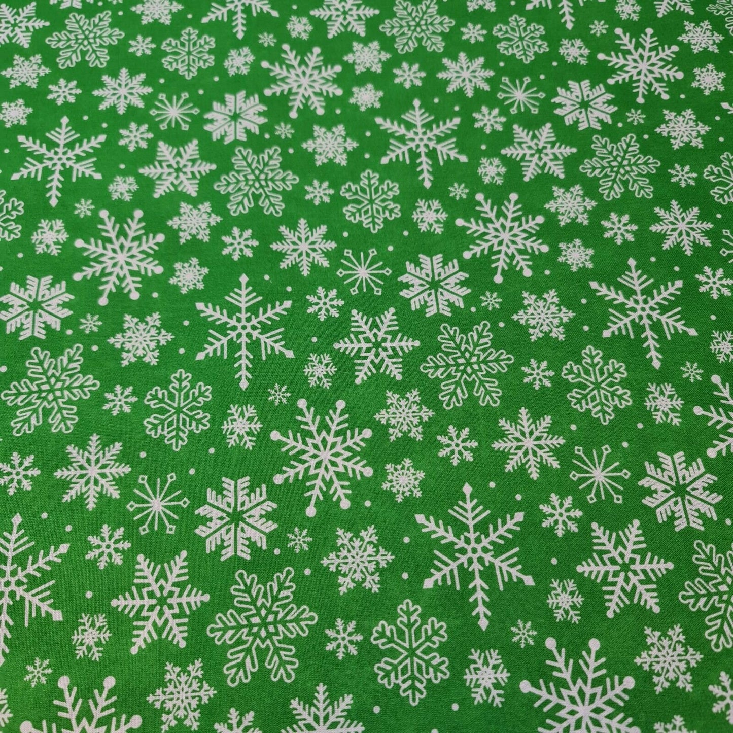 green christmas fabric with snowflakes print for craft and decor