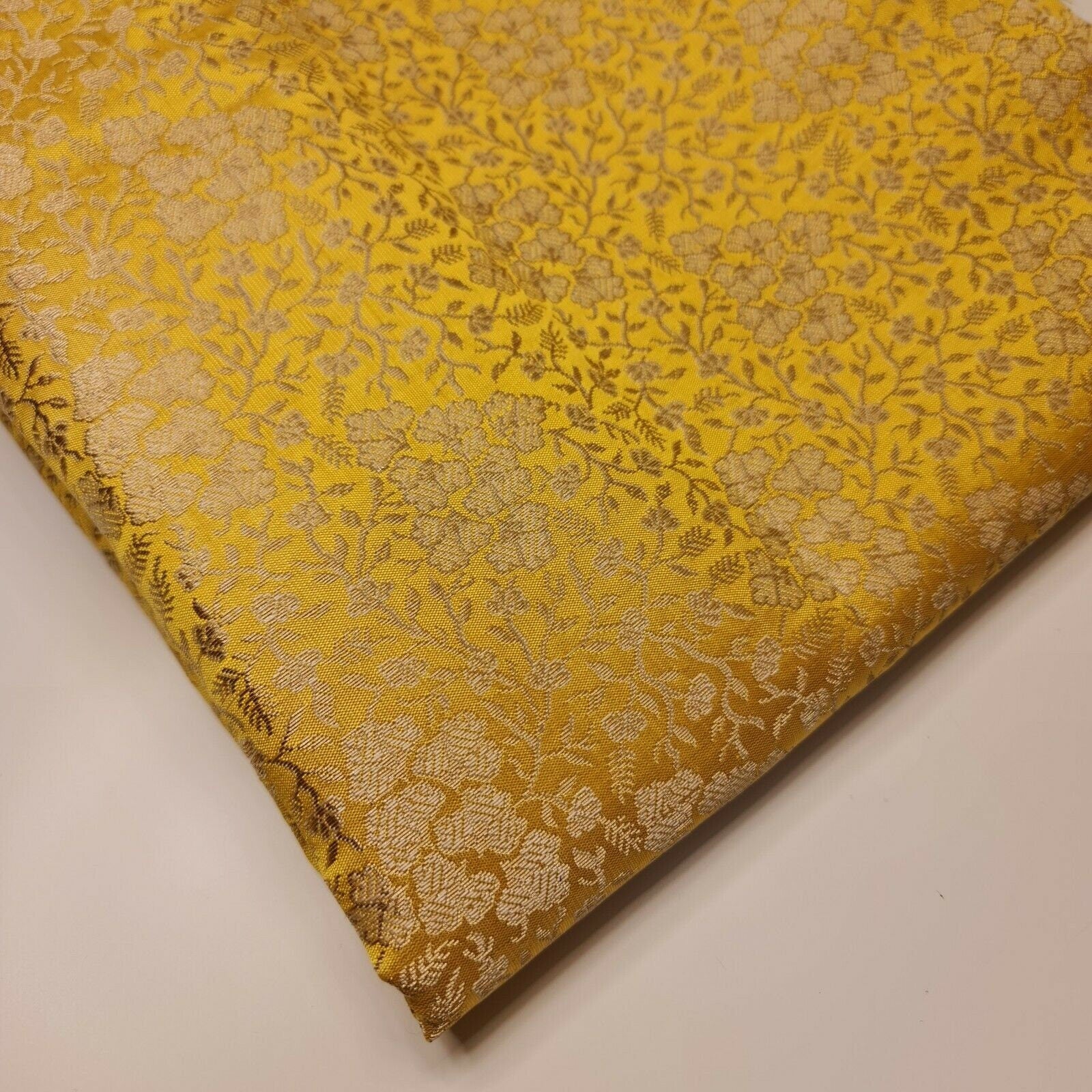 yellow brocade fabric with floral gold metallic print
