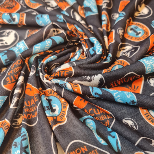 Dinosaur Cotton Jersey Fabric – “Evacuate Isla Nublar” Baby Grow Material (Soft Stretch, 58” Wide) By the Meter
