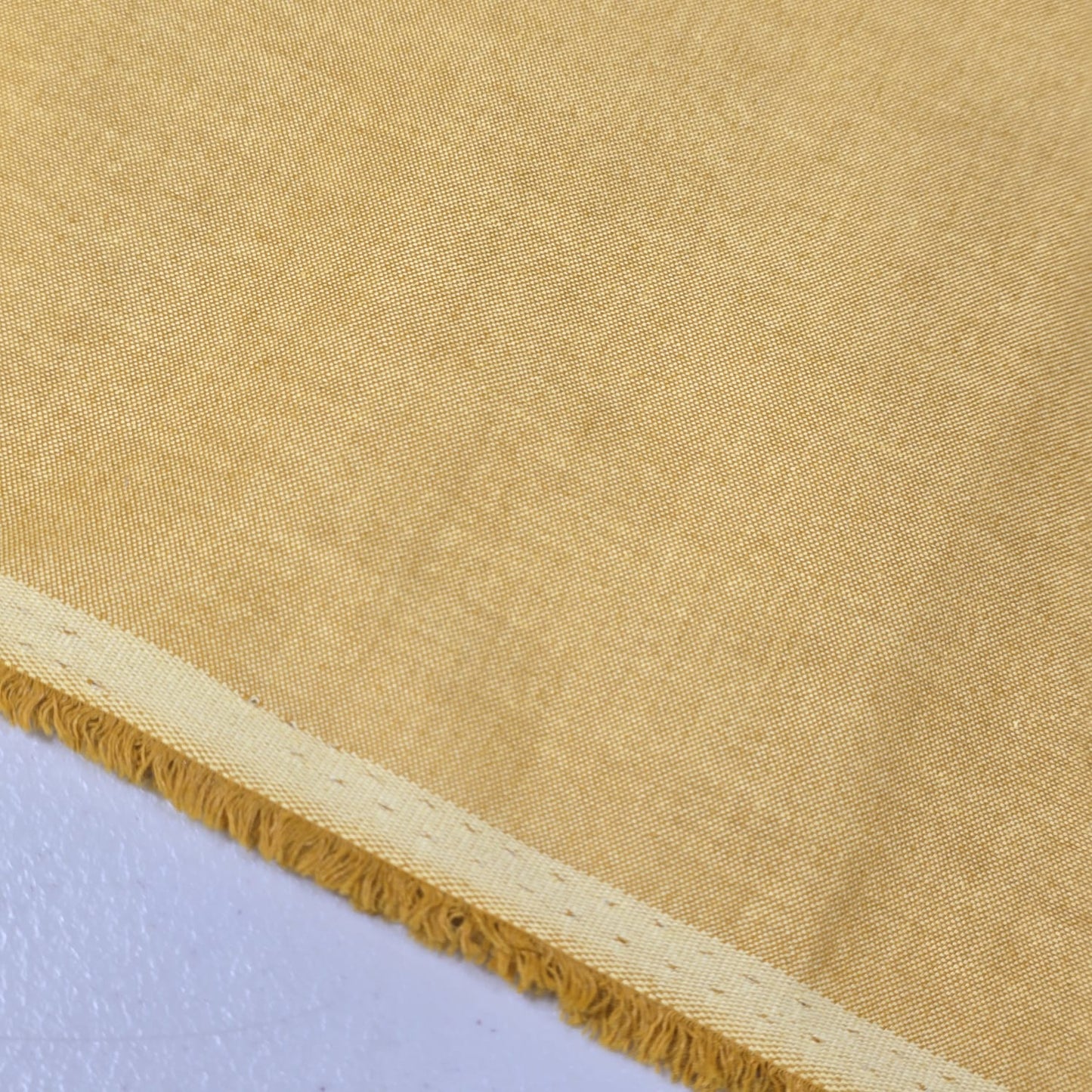 Camel 100% Cotton Chambray fabric draped to display its soft lightweight woven texture, 58-inch wide dressmaking fabric sold by the metre.