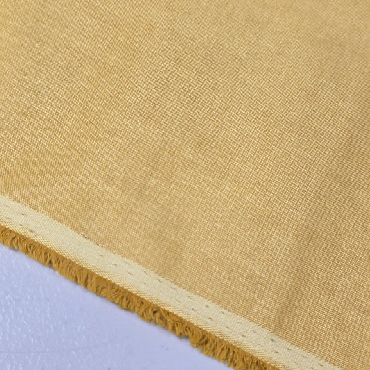 Camel 100% Cotton Chambray fabric draped to display its soft lightweight woven texture, 58-inch wide dressmaking fabric sold by the metre.