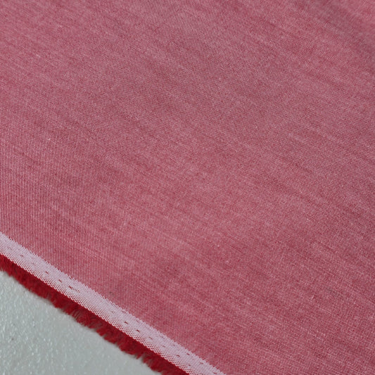 Dusty Rose 100% cotton chambray fabric draped to showcase its soft lightweight woven texture, 58-inch wide dressmaking fabric sold by the metre.