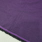 Purple 100% cotton chambray fabric draped to showcase its soft lightweight woven texture, 58-inch wide dressmaking fabric sold by the metre.