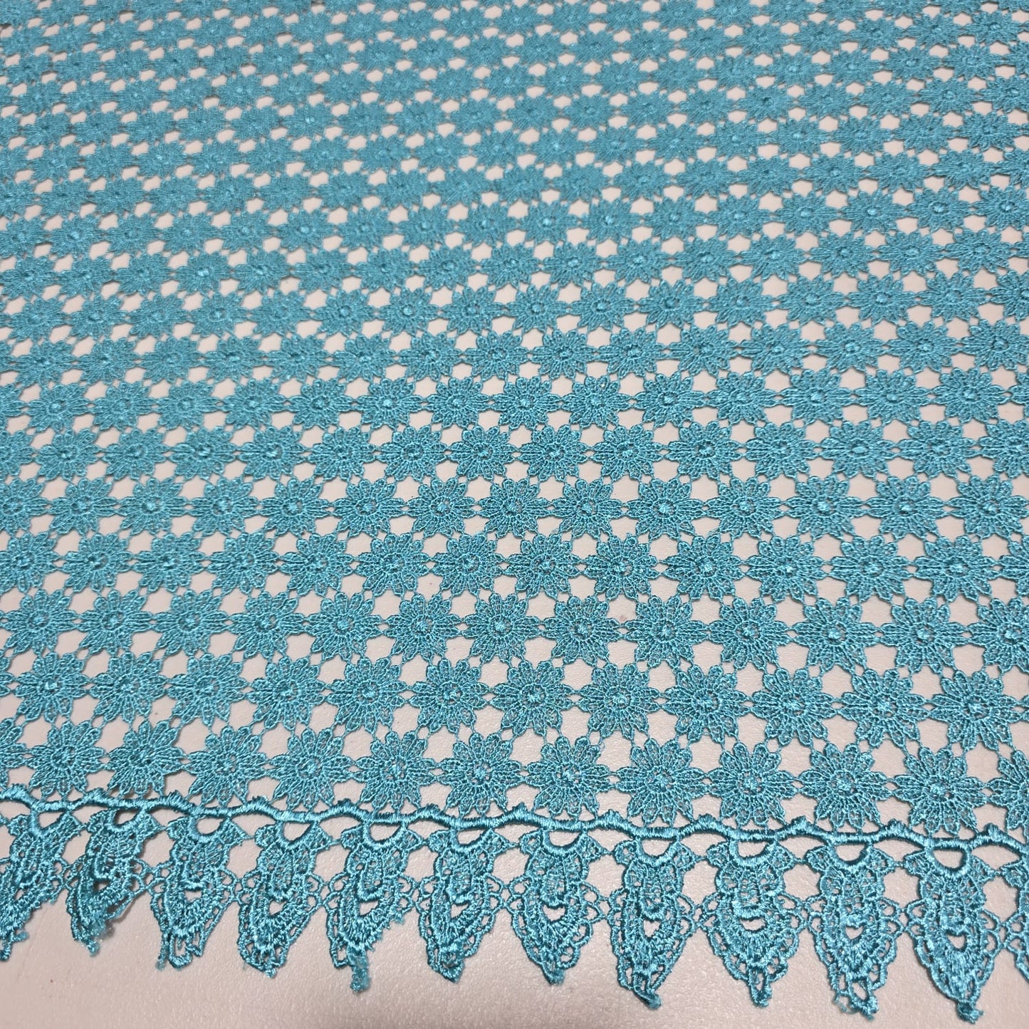 Turquoise mesh lace fabric with scalloped border