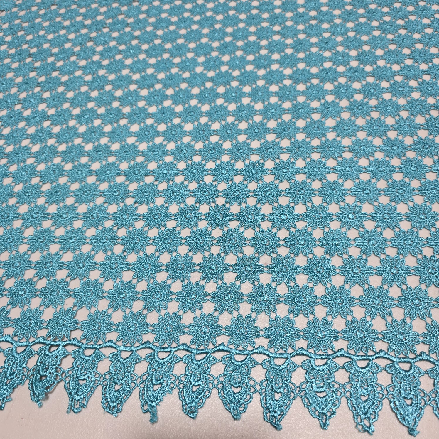 Turquoise mesh lace fabric with scalloped border