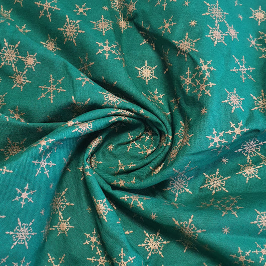 green christmas fabric with gold snowflakes print