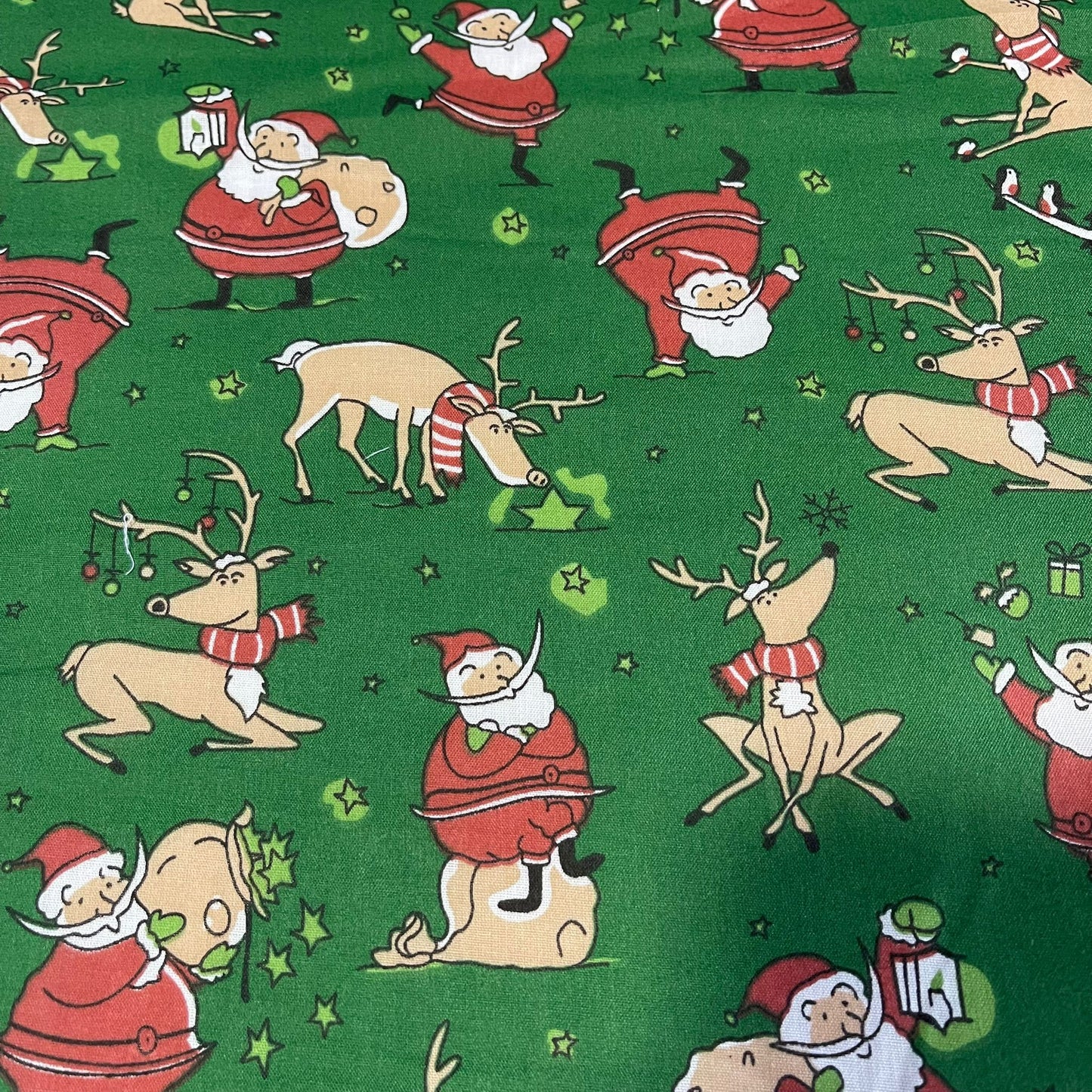 green christmas polycotton fabric uk with santa and reindeer print