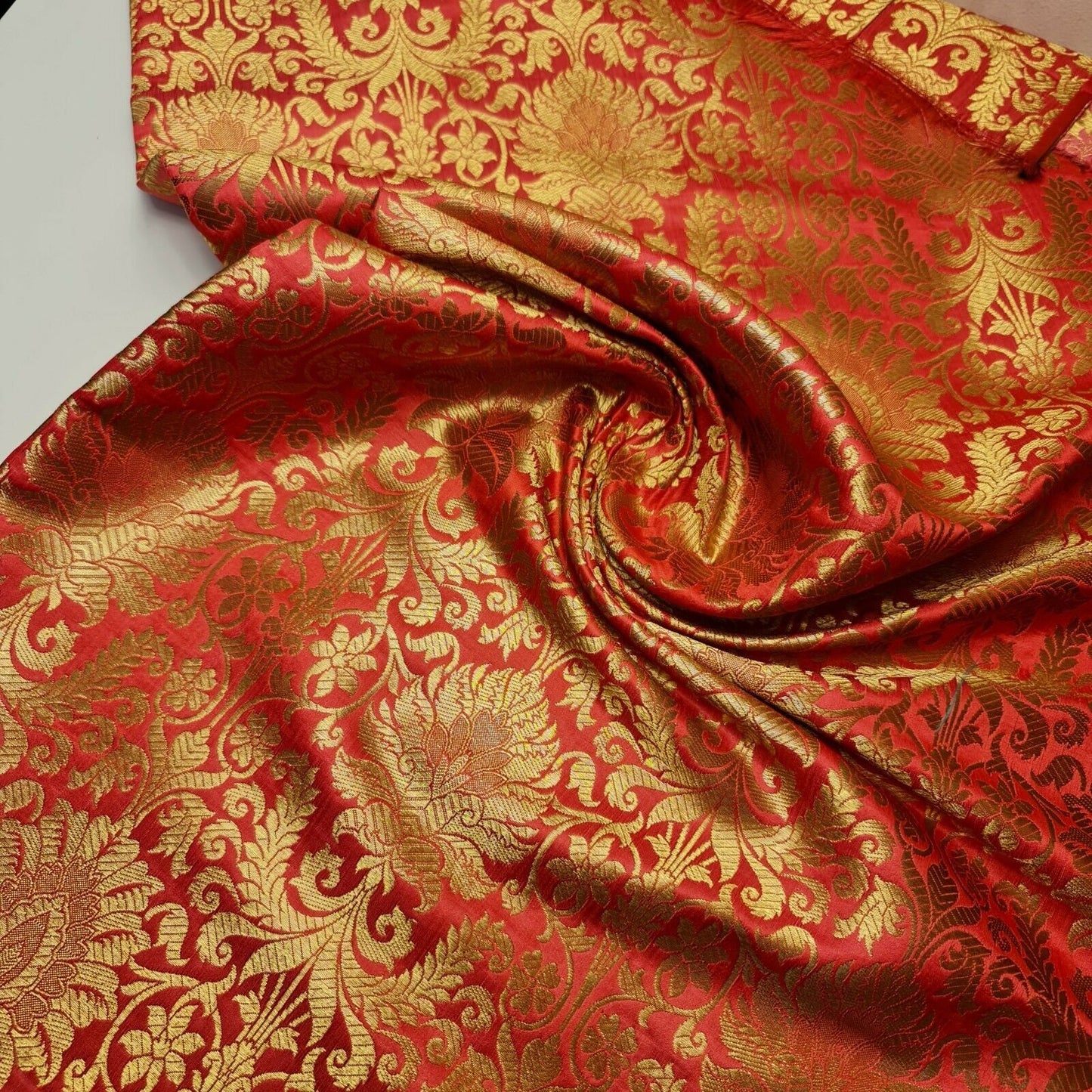 coral pink brocade fabric with floral design