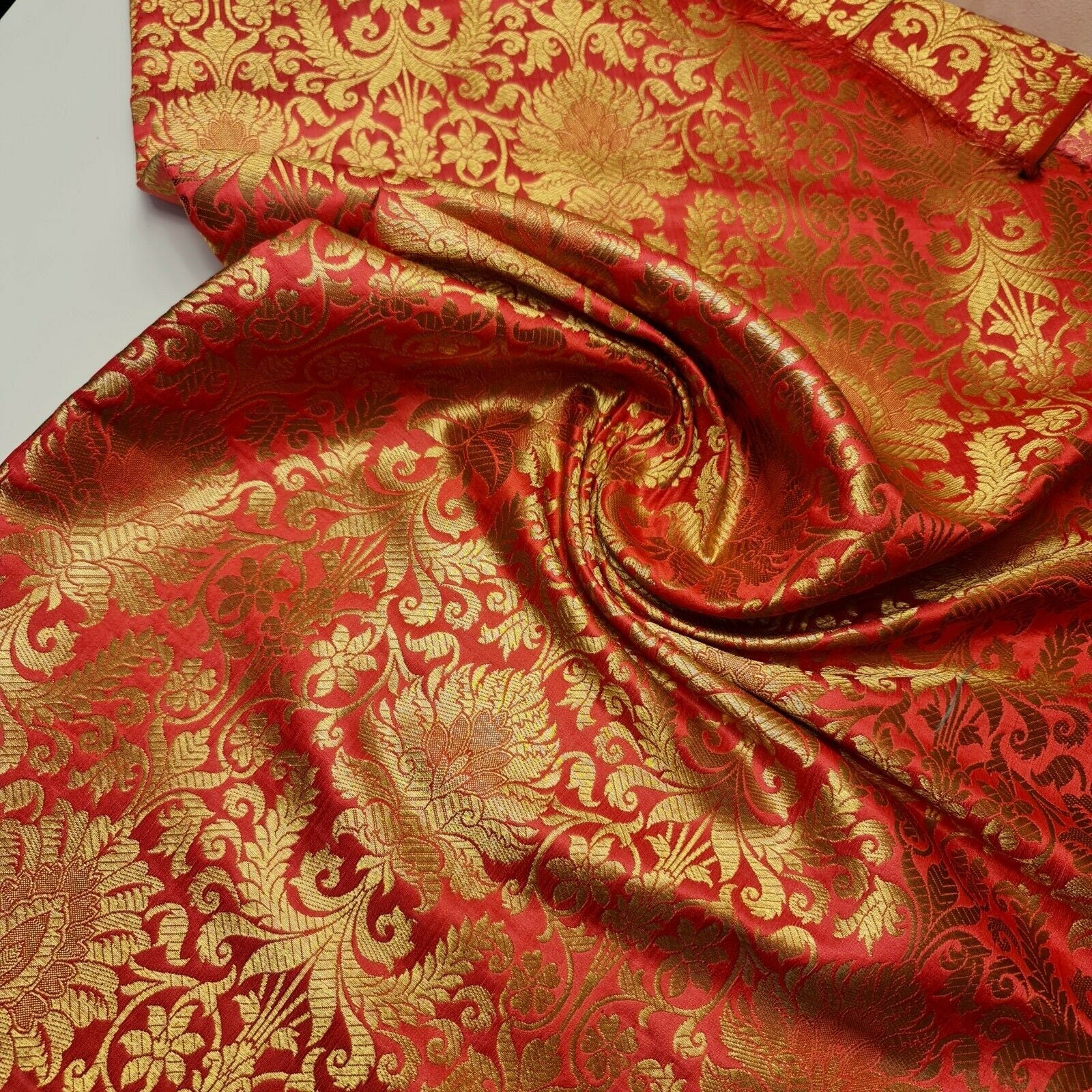 coral pink brocade fabric with floral design