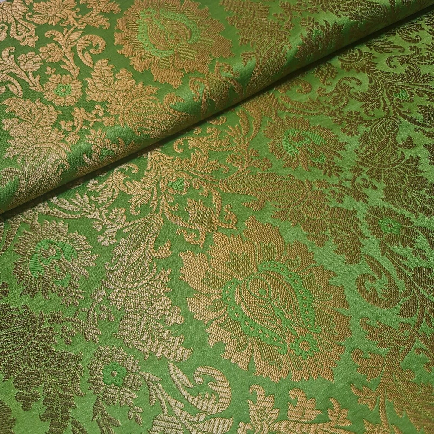 green brocade material with floral print