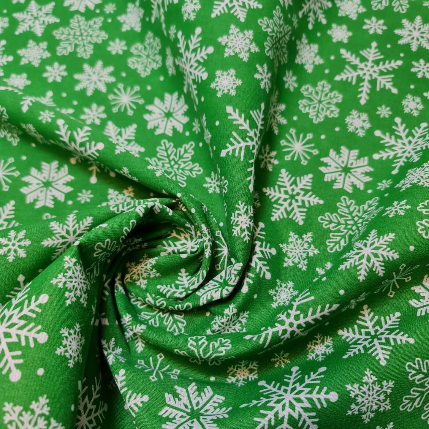 green christmas fabric by the metre with snowflakes print