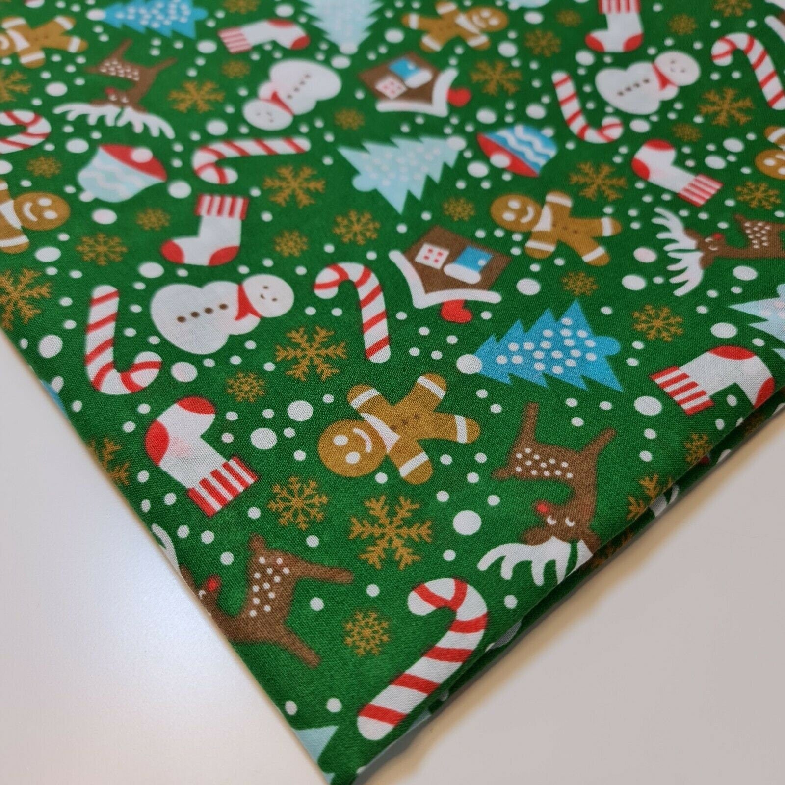 green xmas fabric by the metre with ginger mane snowflakes and tree print
