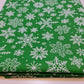 green xmas material by the metre with snowflakes print