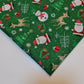 green xmas polycotton material with santa, snowman, reindeer, and tree print