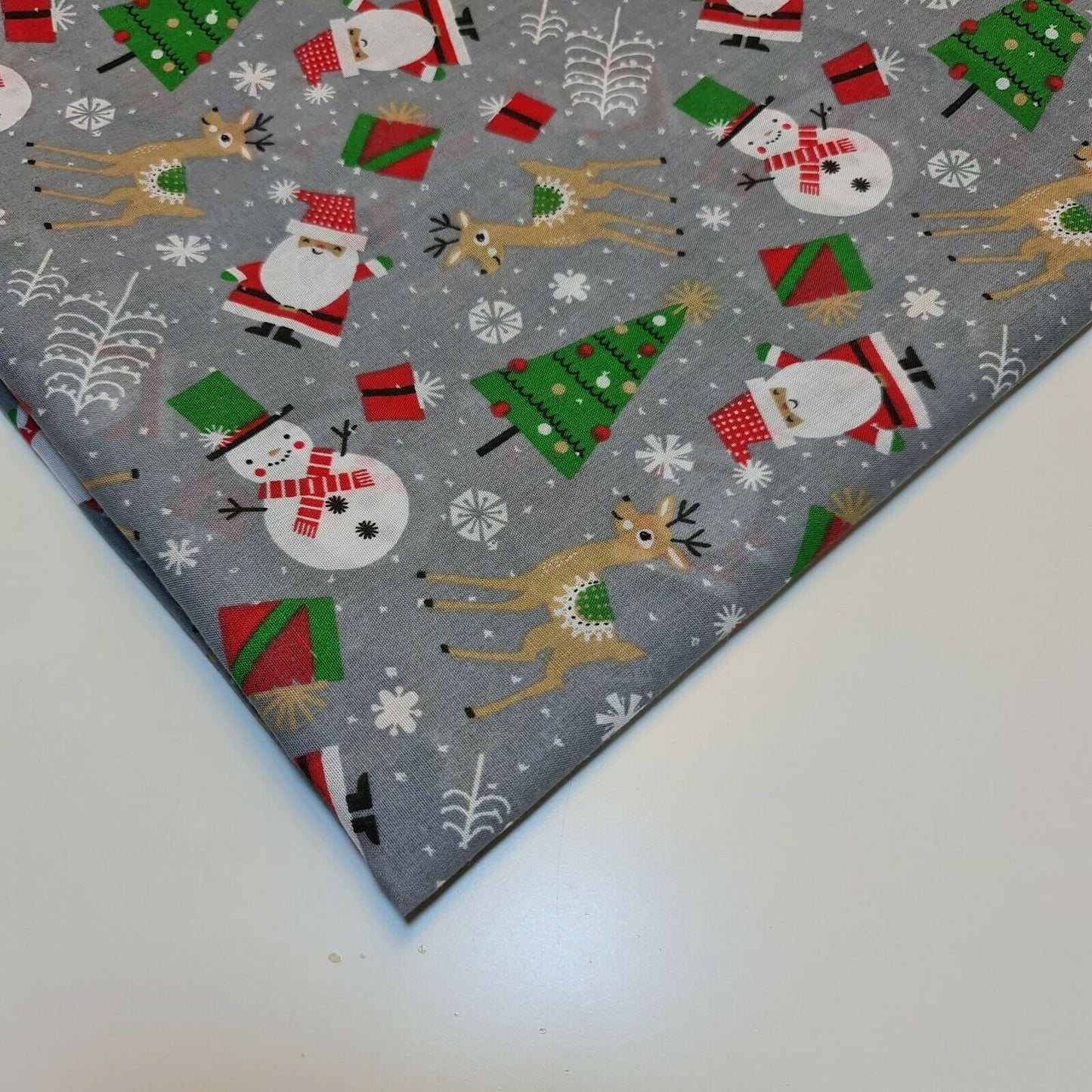 grey xmas polycotton material with santa, snowman, reindeer, and tree print