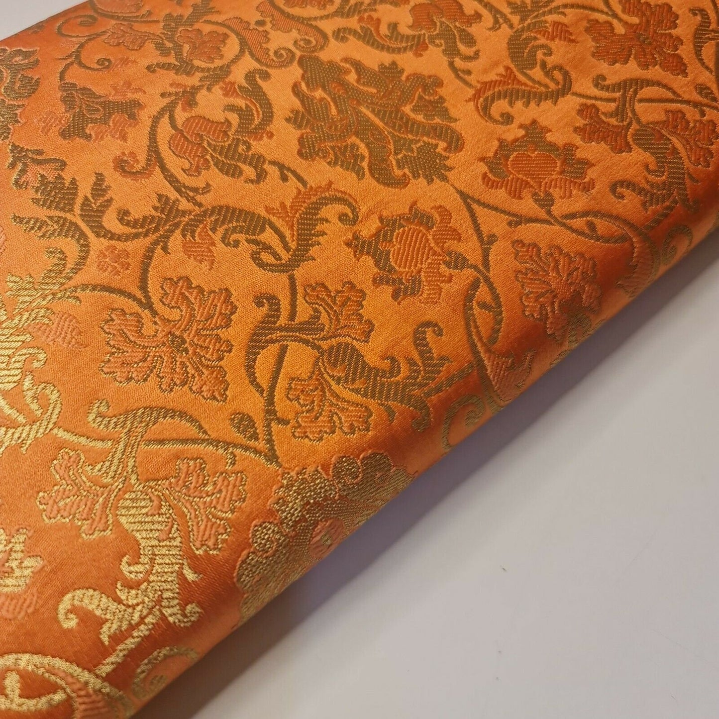 orange brocade fabric with floral print