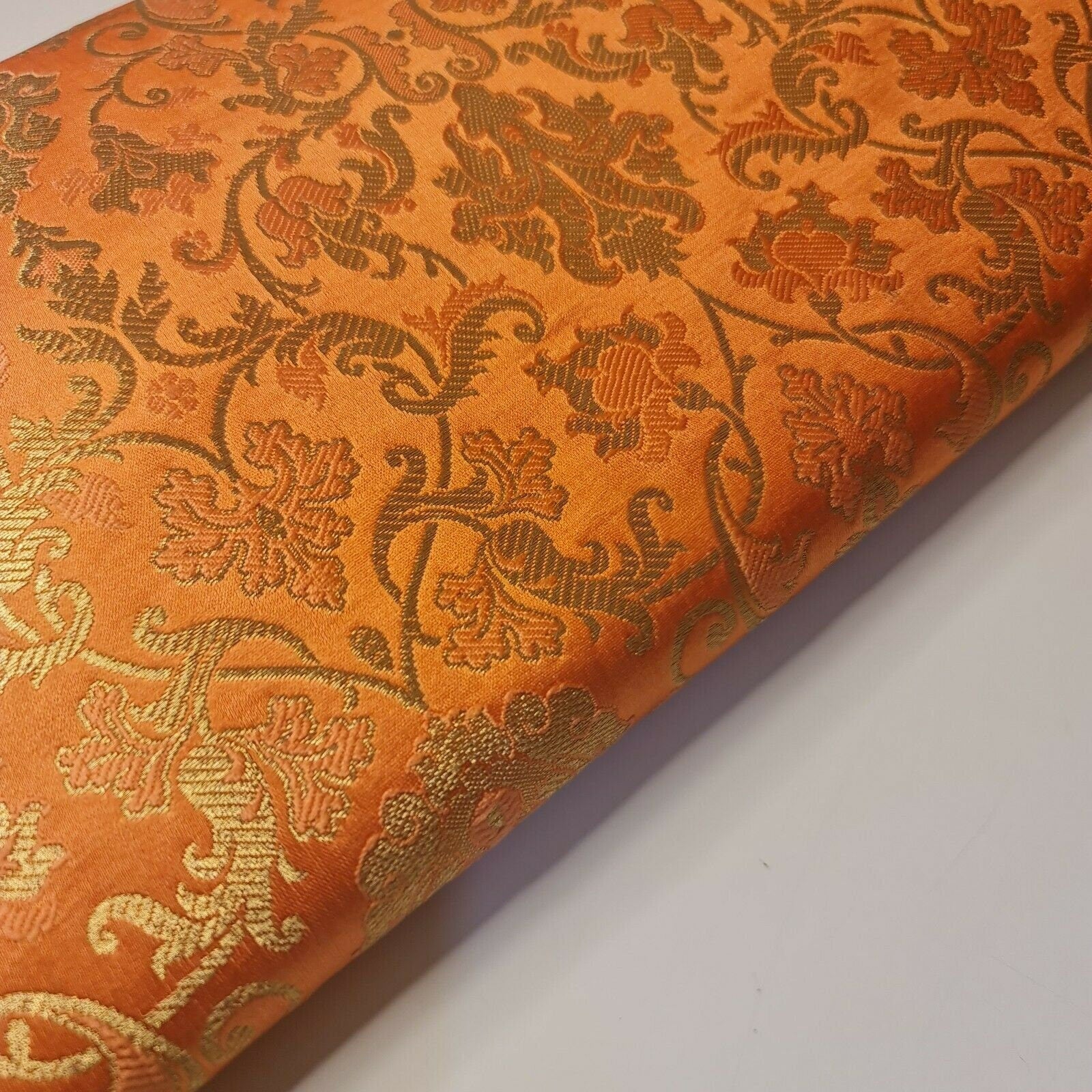 orange brocade fabric with floral print