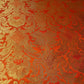 orange brocade material fabric with gold metallic floral print