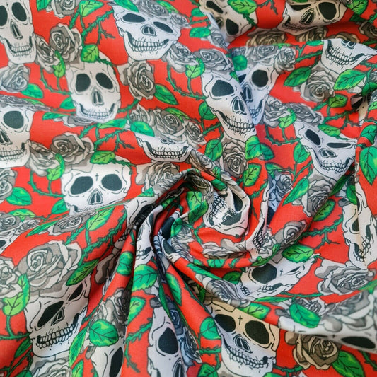red halloween fabric with skulls and roses print