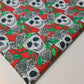 red halloween material fabric with roses and skulls print