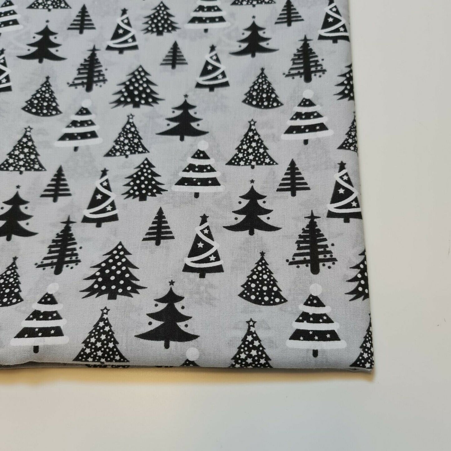 silver xmas material with tree print for dressmaking and crafting